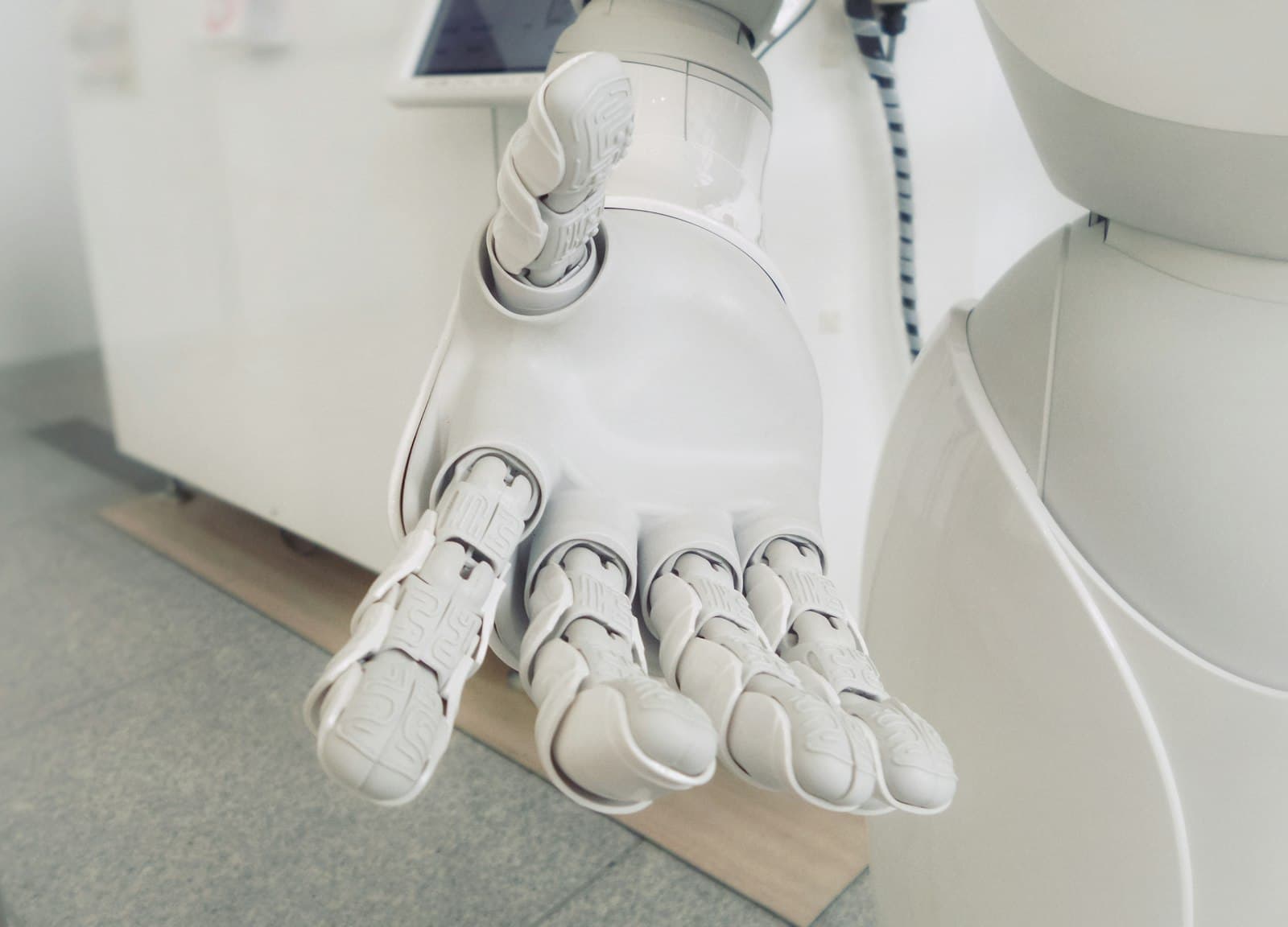 Robot hand reaching toward a human hand